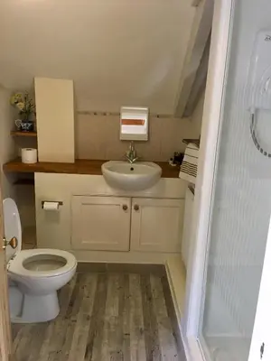 a bathroom with a toilet and a sink at Culloden Farmhouse in Camelford