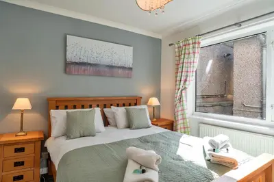 a bedroom with a bed and a window at Finest Retreats - No 5 Harlequin in St Ives