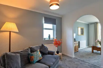 a living room with a couch and a mirror at Finest Retreats - No 5 Harlequin in St Ives