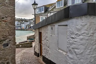 a white building with a window and a street at Finest Retreats - No 5 Harlequin in St Ives