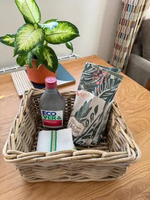 a basket on a table with a bottle of water at Acorn Lodge Pentewan in St Austell