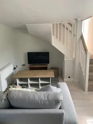 a living room with a couch and a flat screen tv at Gorgeous cottage for couples & small families in Saint Columb Minor