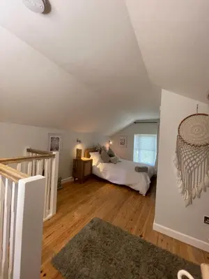 a bedroom with a bed in a attic at Gorgeous cottage for couples & small families in Saint Columb Minor