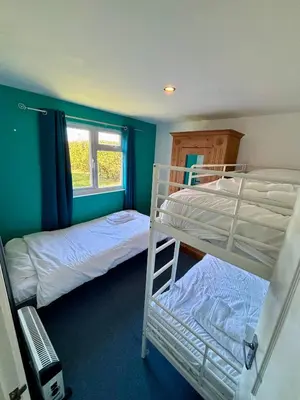 a bedroom with two bunk beds and a window at 5 Berth Chalet Holiday Apartment in Cornwall in Padstow