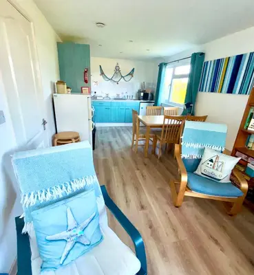 a living room with a kitchen and a dining room at 5 Berth Chalet Holiday Apartment in Cornwall in Padstow