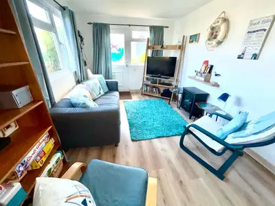 a living room with a couch and a tv at 5 Berth Chalet Holiday Apartment in Cornwall in Padstow