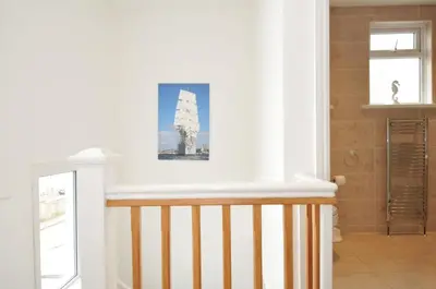 a room with a staircase with a picture on the wall at Falmouth Bay 2 in Falmouth