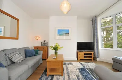 a living room with a couch and a tv at Falmouth Bay 2 in Falmouth