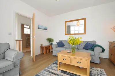 a living room with two couches and a table at Falmouth Bay 2 in Falmouth