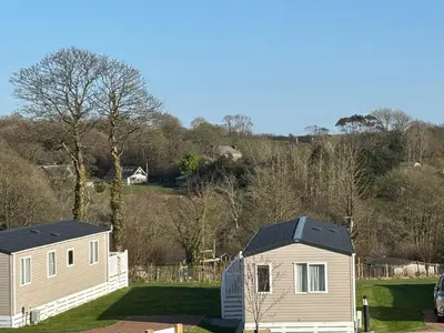 a house with a solar roof on a yard at Two bedroom Holiday Home with countryside view in St Austell
