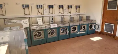 a row of washing machines in a laundry room at HolidayLet 24 Bude Newperran Holiday Park in Cubert