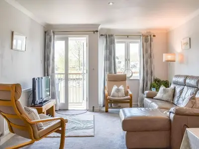 a living room with a couch and a tv at Camelside in Wadebridge
