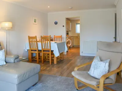 a living room with a table and chairs at Camelside in Wadebridge