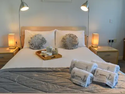 a bedroom with a large bed with a tray of candles at Camelside in Wadebridge