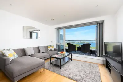 a living room with a couch and a tv at 32 One Lusty Glaze in Newquay in Newquay