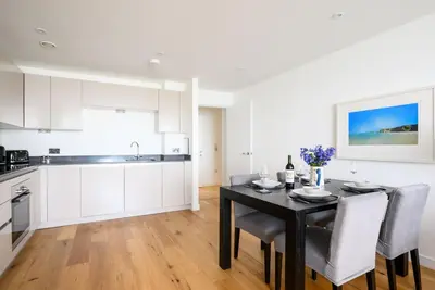 a kitchen and dining room with a table and chairs at 32 One Lusty Glaze in Newquay in Newquay
