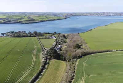 an aerial view of a field and a lake at Schoopers - Holiday Home in Rock in Padstow