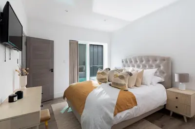 a bedroom with a large bed with a television at 26 Cliff Edge Penthouse in Newquay in Newquay