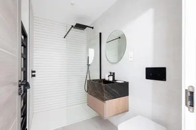 a bathroom with a sink and a mirror at 26 Cliff Edge Penthouse in Newquay in Newquay