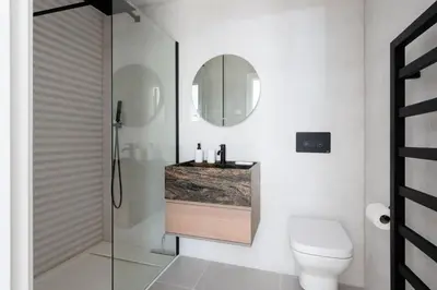 a bathroom with a toilet and a sink and a mirror at 26 Cliff Edge Penthouse in Newquay in Newquay
