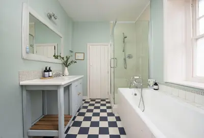 a bathroom with a tub and a sink and a shower at Aloe Cottage in Padstow