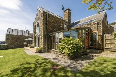 an exterior view of a brick house with a yard at Gull Rock in Padstow