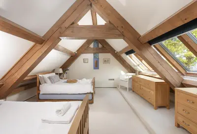 a bedroom with two beds in a attic at Gull Rock in Padstow
