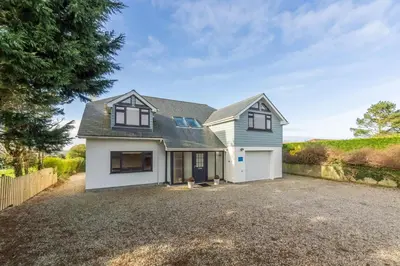a house with a garage and a driveway at Highcroft in Saint Minver
