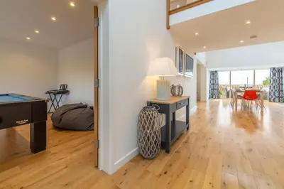 a living room with a pool table and a desk at Highcroft in Saint Minver