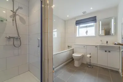 a bathroom with a shower and a toilet and a sink at Highcroft in Saint Minver