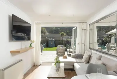 a living room with a couch and a table at Bluebirds in Polzeath