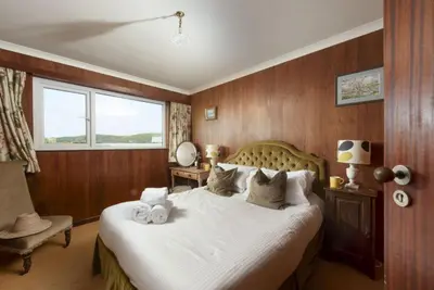 a bedroom with a bed with two towels on it at Rabbit Hill in Polzeath