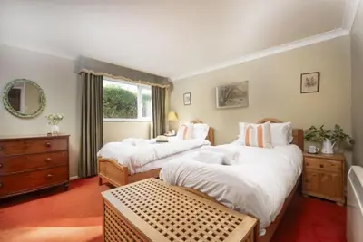 a bedroom with two beds and a window at Rabbit Hill in Polzeath
