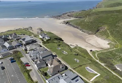 an aerial view of a beach and houses at Rockside Studio in Polzeath