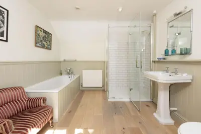 a bathroom with a tub and a sink and a shower at Sparnal Stitch in Padstow