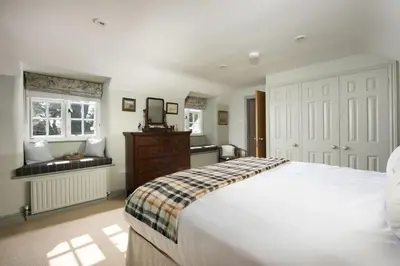 a bedroom with a large white bed and a window at Sparnal Stitch in Padstow