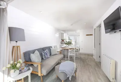 a living room with a couch and a table at Robin in Polzeath