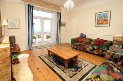 a living room with a couch and a coffee table at Trevose View in Polzeath