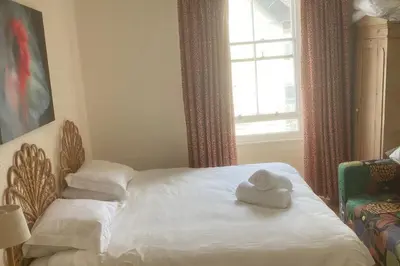 a bed with two towels on it with a window at Trevose View in Polzeath