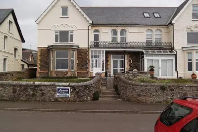 a house with a for sale sign in front of it at Trevose View in Polzeath