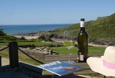 a bottle of wine and a glass on a table at The Perch Studio in Polzeath