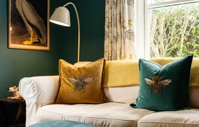a couch with two pillows on it in a living room at Trerair in Saint Minver