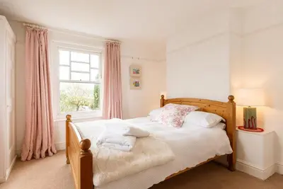 a bedroom with a bed with pillows and a window at Trerair in Saint Minver