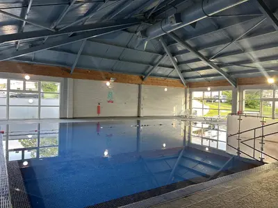 a large indoor swimming pool in a building at Satinwood in Newquay