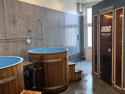 a bathroom with two wooden barrels and a shower at Satinwood in Newquay