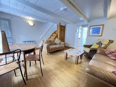 a living room with a couch and a table at The Nest in St Ives