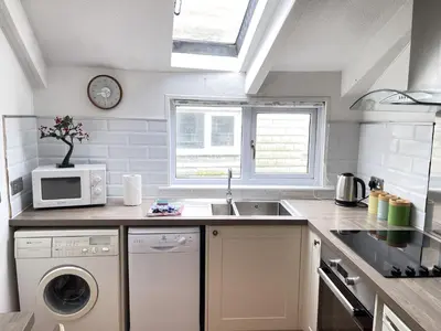 a kitchen with a sink and a microwave at The Nest in St Ives