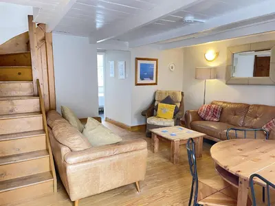 a living room with a couch and a table at The Nest in St Ives