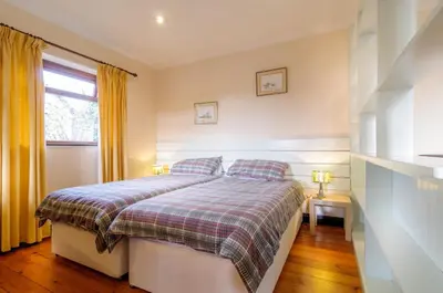 a bedroom with a bed and a window at Shilbury Retreat Cottage near Perranporth in Perranporth