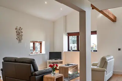 a living room with a couch and chairs and a tv at Finest Retreats - Trippet Cottage at Bodmin Moor in Saint Breward